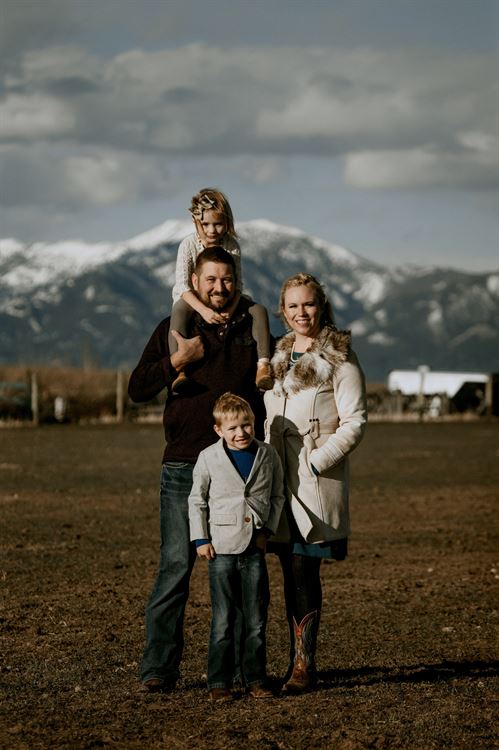 family standing in front of mountains